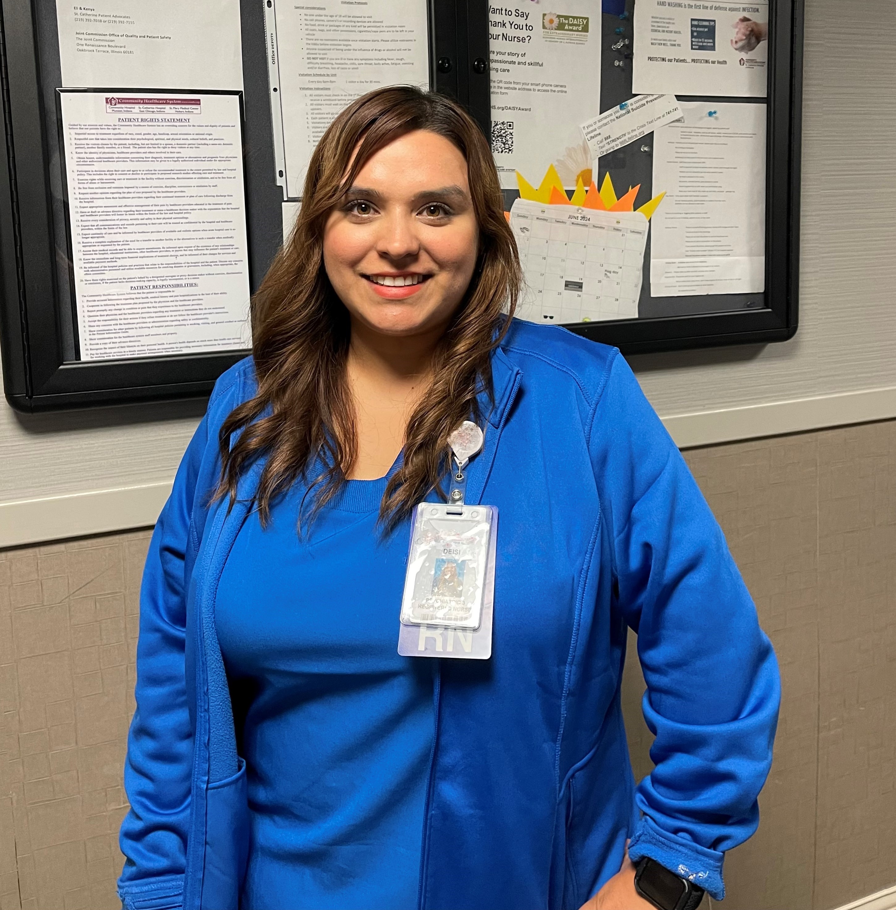 Deisi Garza standing in front of bulletin board